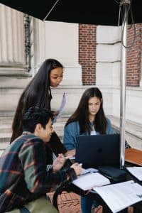 diverse group sitting outside studying